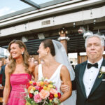The bride heading down the aisle with her parents, Kimberly and